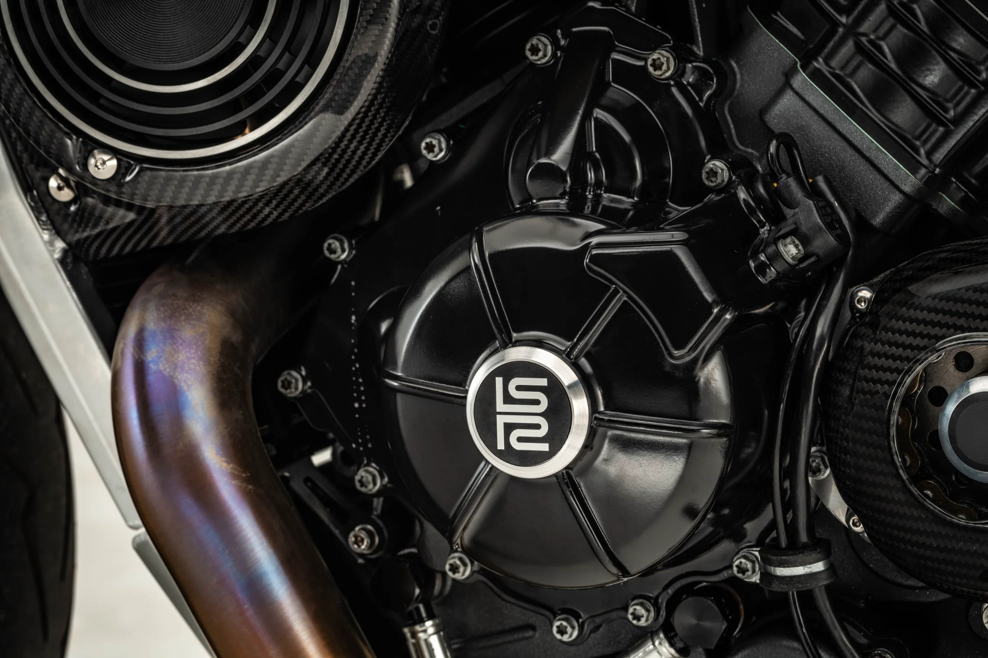 Lightspeed engine cover with the LS mark, carbon and titanium around it