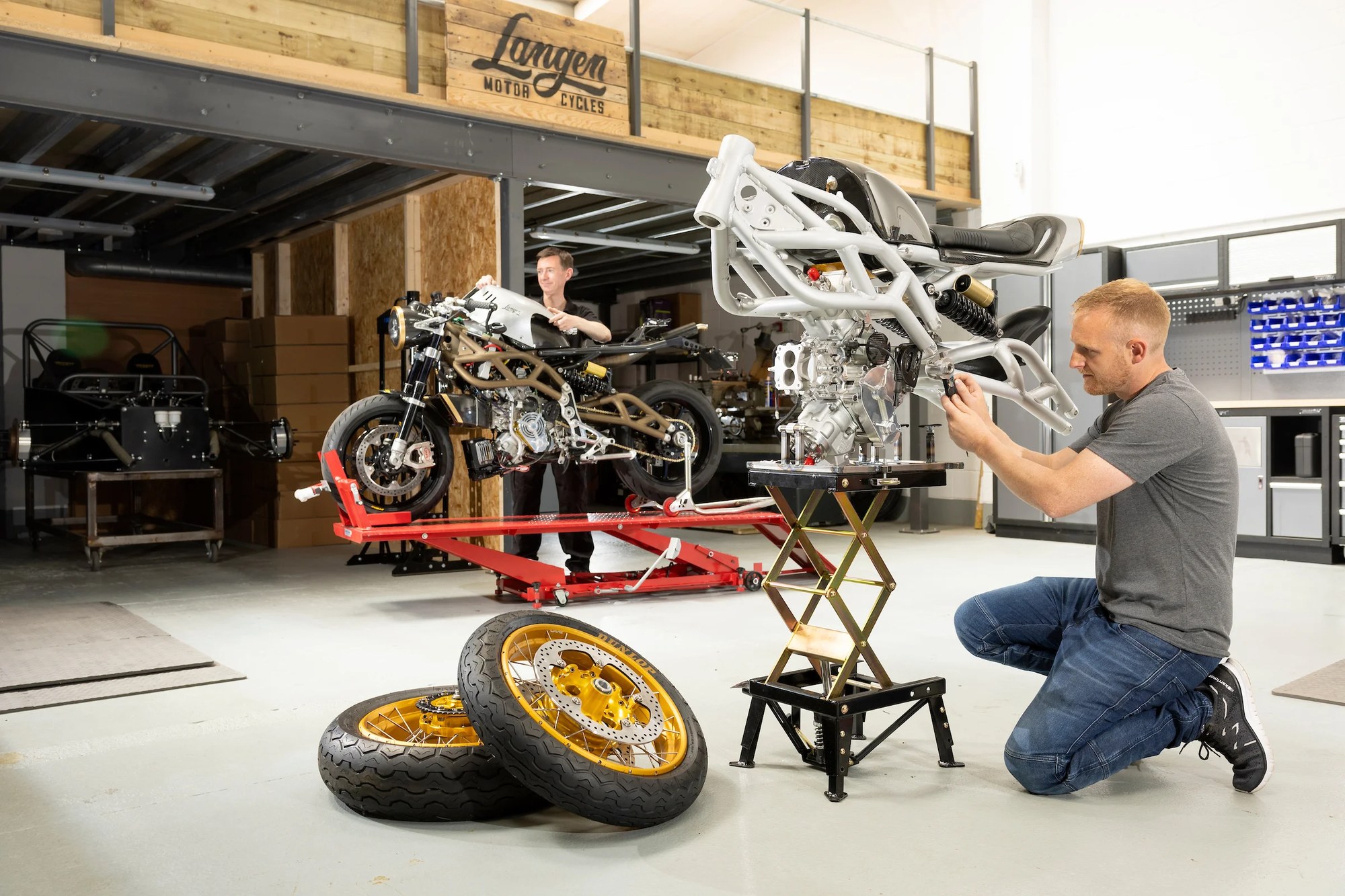 A Langen engineer fitting a Two Stroke chassis in the workshop