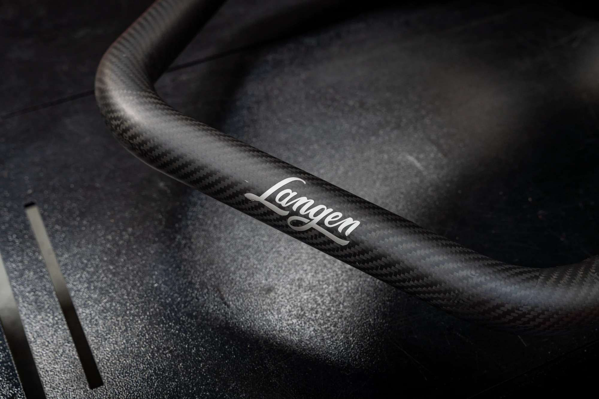 Carbon exhaust shroud with the Langen script