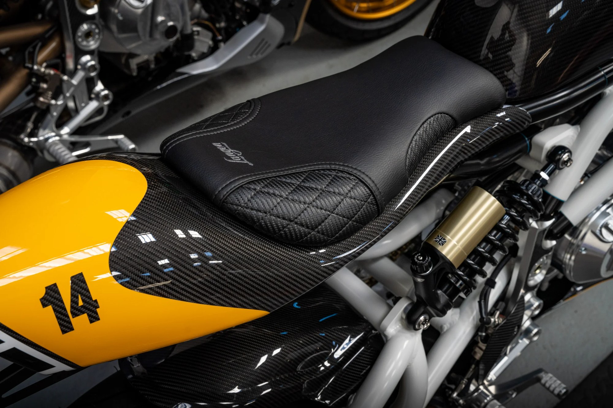 Two Stroke number 14 in yellow with a quilted seat